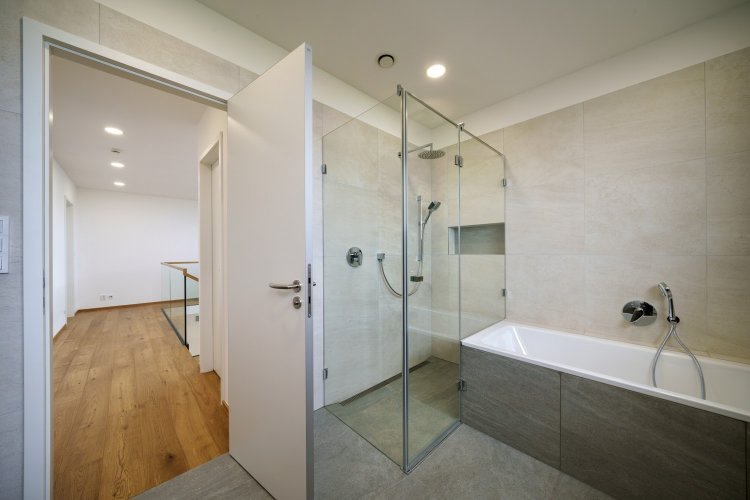 Skleněný sprchový kout v koupelně moderního rodinného domu
